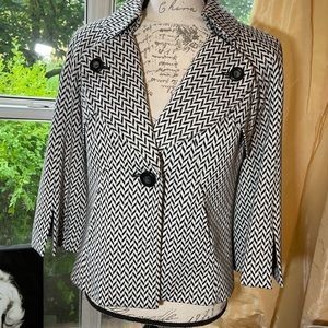 Herringbone design blazer.  3/4 sleeve.  Very comfortable and flattering on.